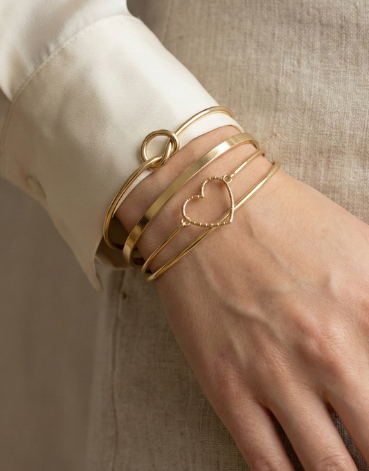 4-Piece Gold Stackable Bracelet Set – Heart, Knot & Flat Cuff Design